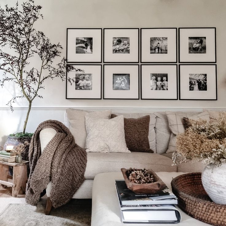 a living room filled with lots of furniture and pictures on the wall above it's coffee table