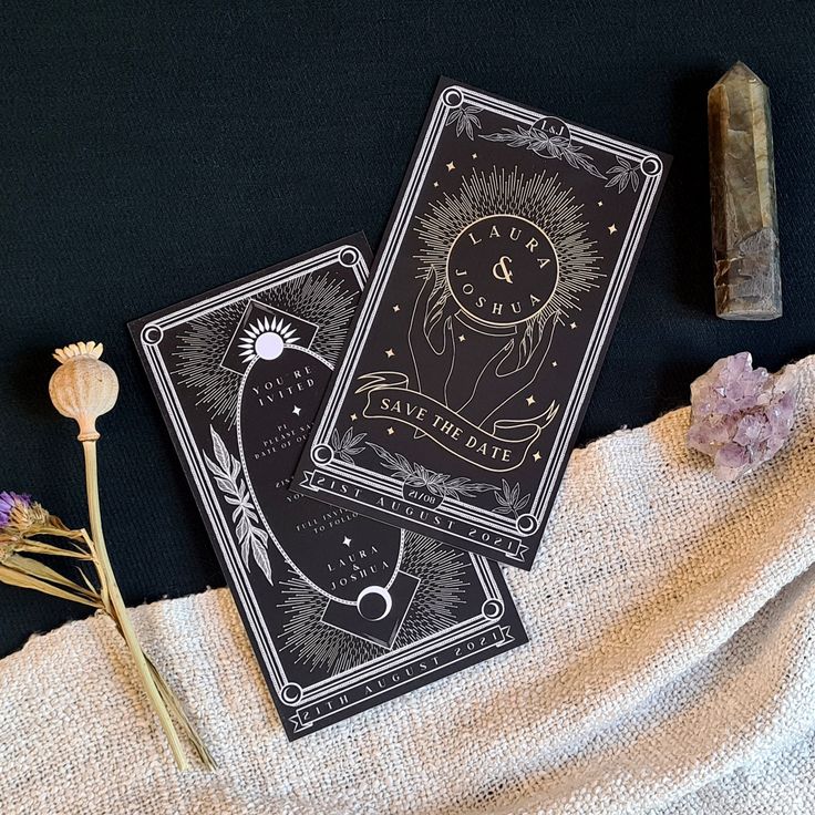 two tarot cards sitting on top of a cloth