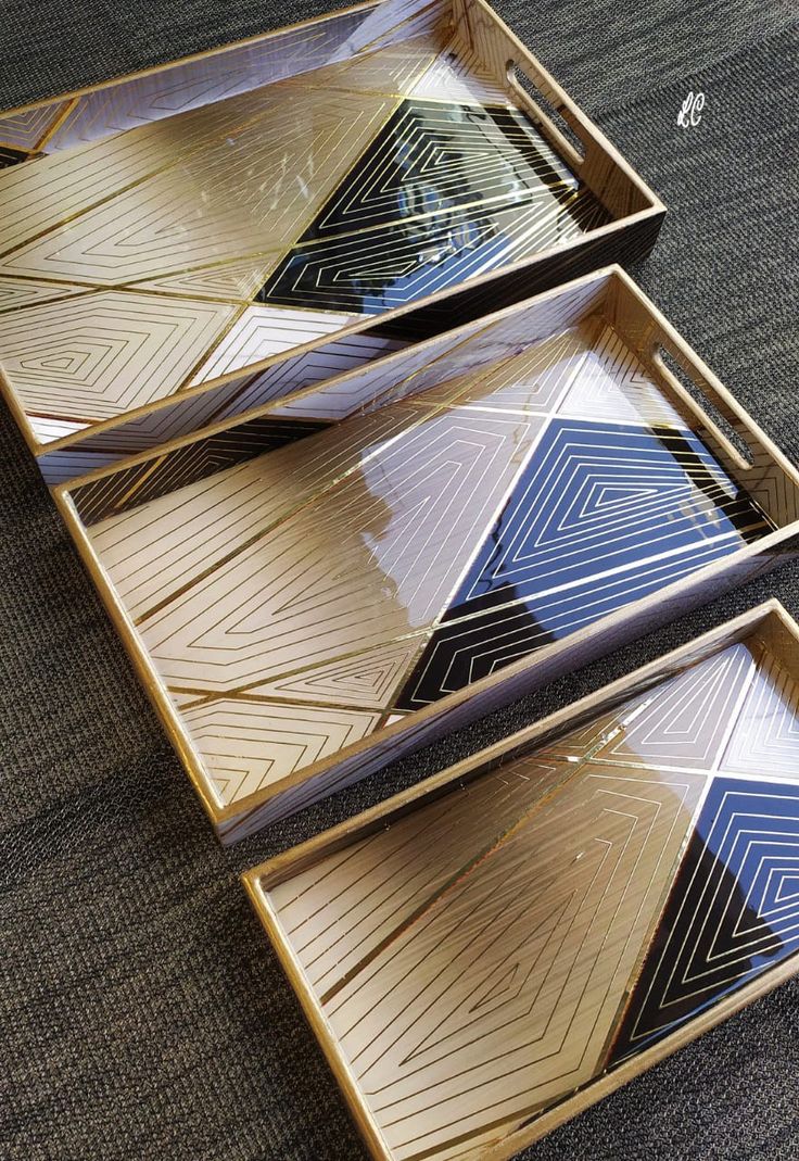 three decorative trays sitting on top of a carpeted floor