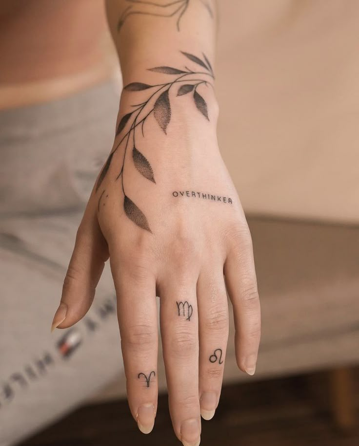 a woman's hand with tattoos on it and the word november written in cursive writing