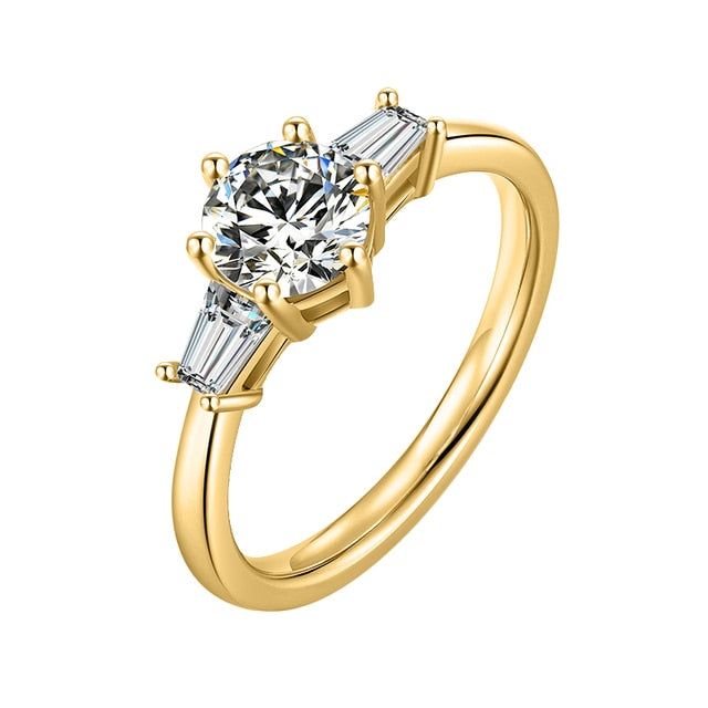 a yellow gold engagement ring with three baguets