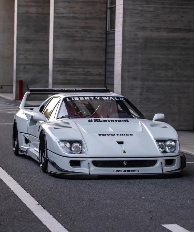 a white sports car parked in front of a building