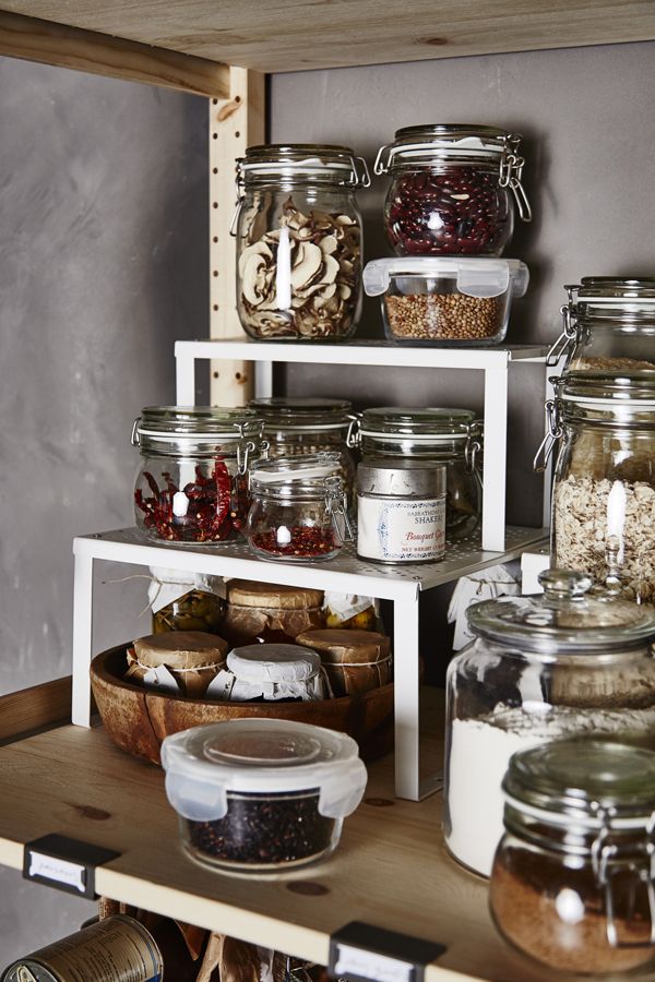 the shelves are filled with many different types of food in jars and containers on them