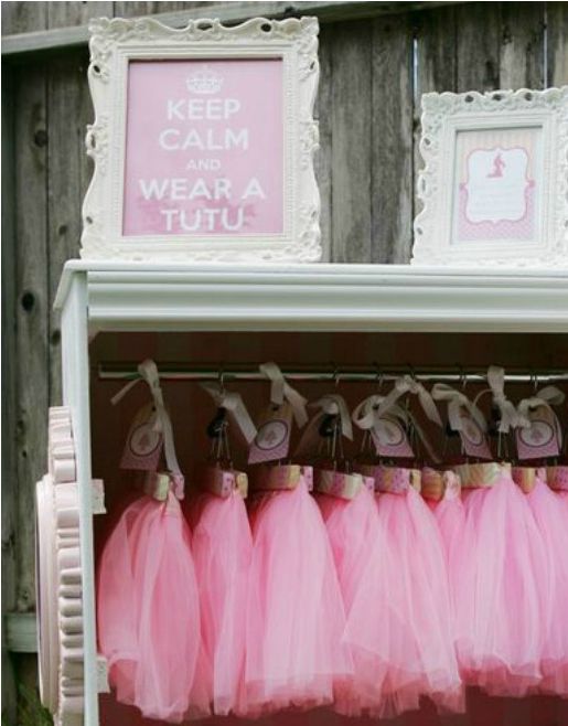 pink tutu skirts are hanging on a shelf