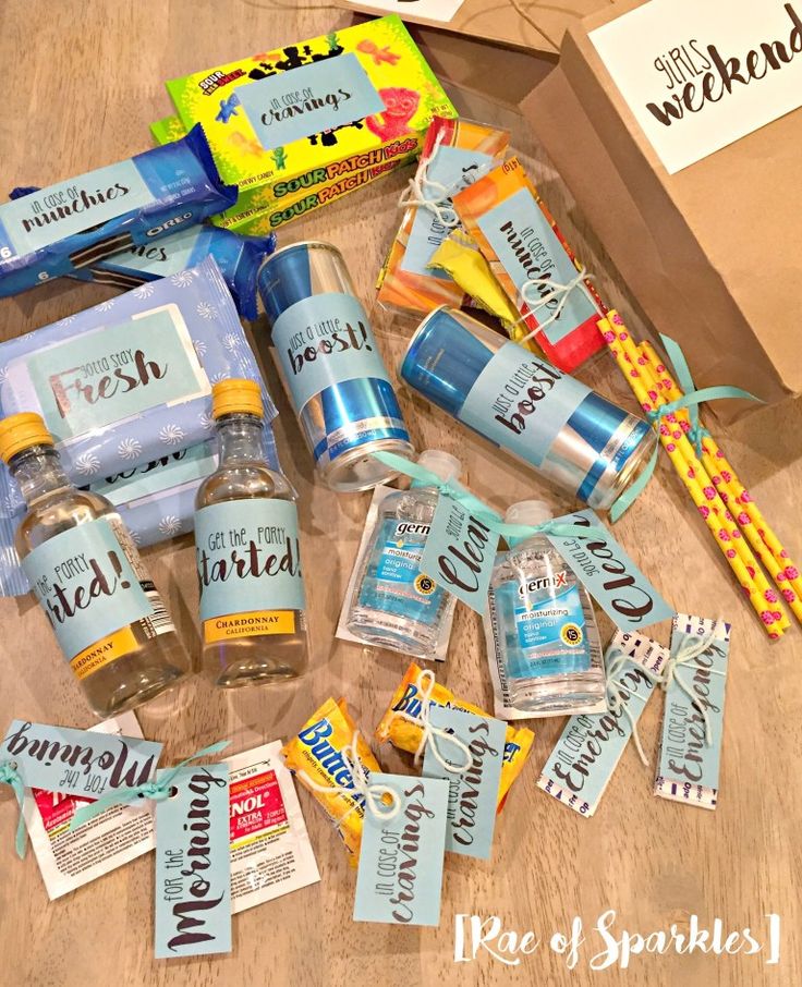 the contents of a personal care kit laid out on top of a wooden table next to a package of toothpaste