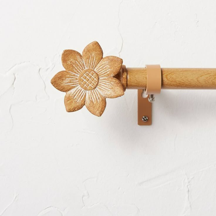 a wooden handle with a flower on it