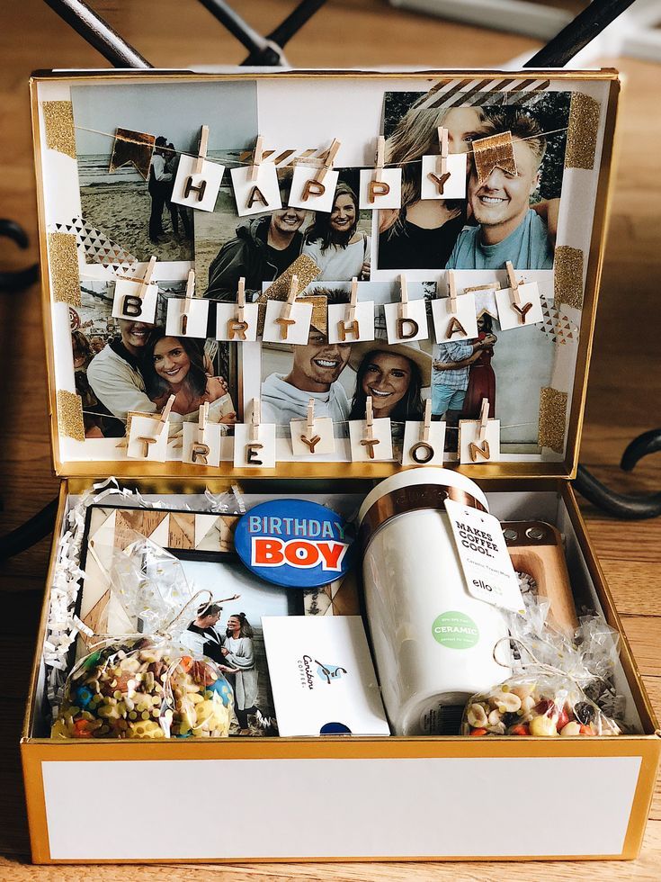 an open birthday gift box filled with personal pictures