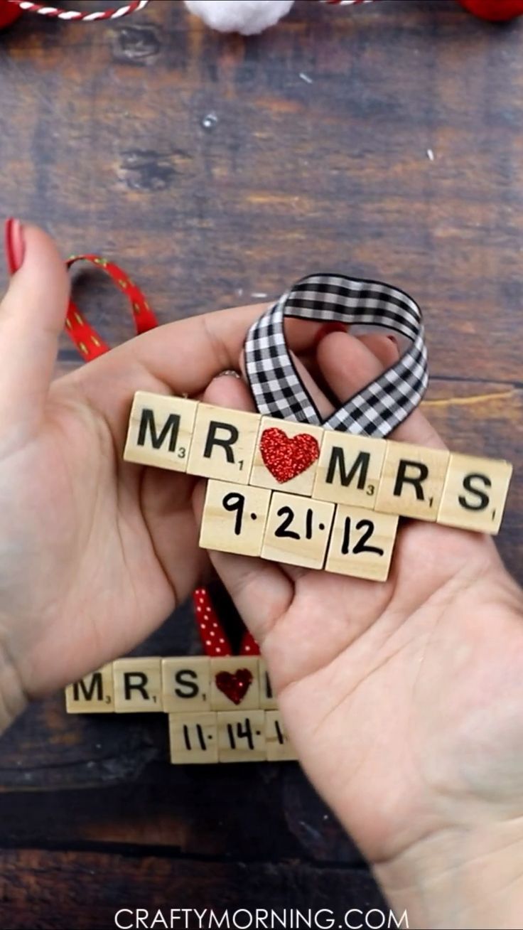 two hands holding scrabbles that spell out the word mr and mrs