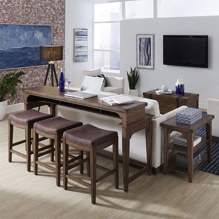 a living room filled with furniture and a flat screen tv mounted on the wall above it