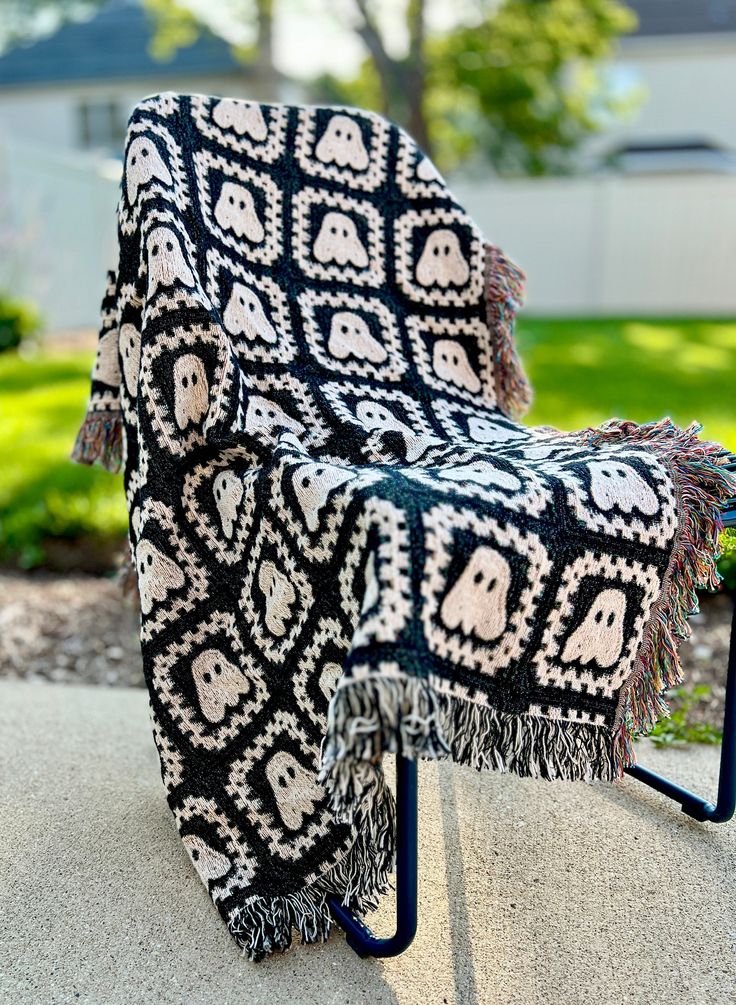 a black and white blanket sitting on top of a chair