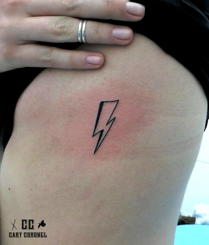 a woman's thigh with a lightning bolt tattoo on her left side ribcage