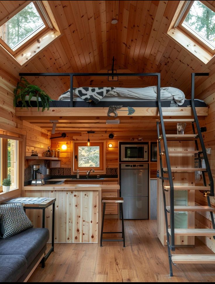 a loft bed in the middle of a living area with stairs leading up to it