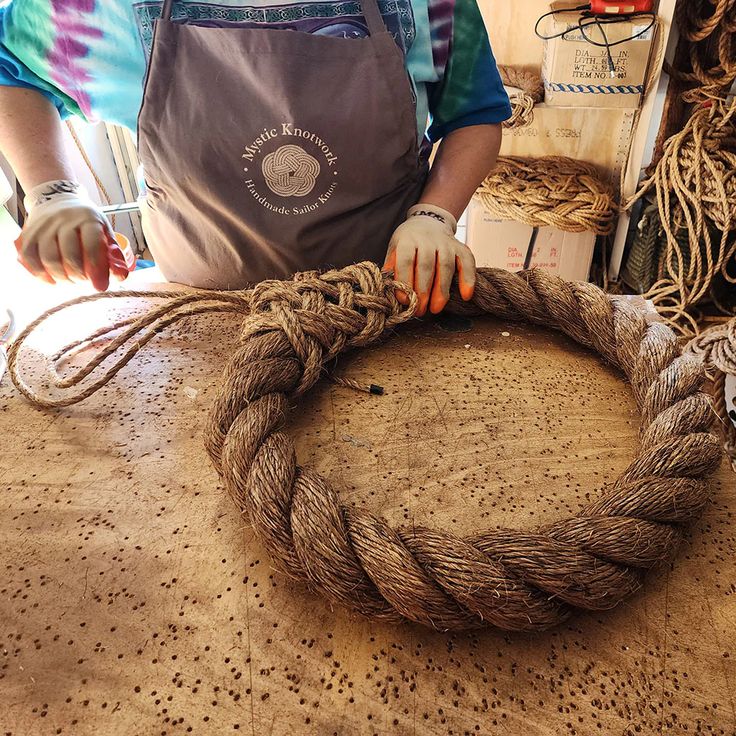 Tying the turk's heads knot on the grommet wreath, Mystic Knotwork Rope Wreath Ideas, Cowhide Ideas, Nautical Landscaping, Nautical Rope Decor, Nautical Wreaths, Rope Wreath Diy, Craft Background, Rope Wreath, Mystic Connecticut