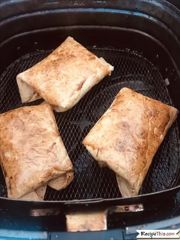 four pieces of food cooking on top of a grill