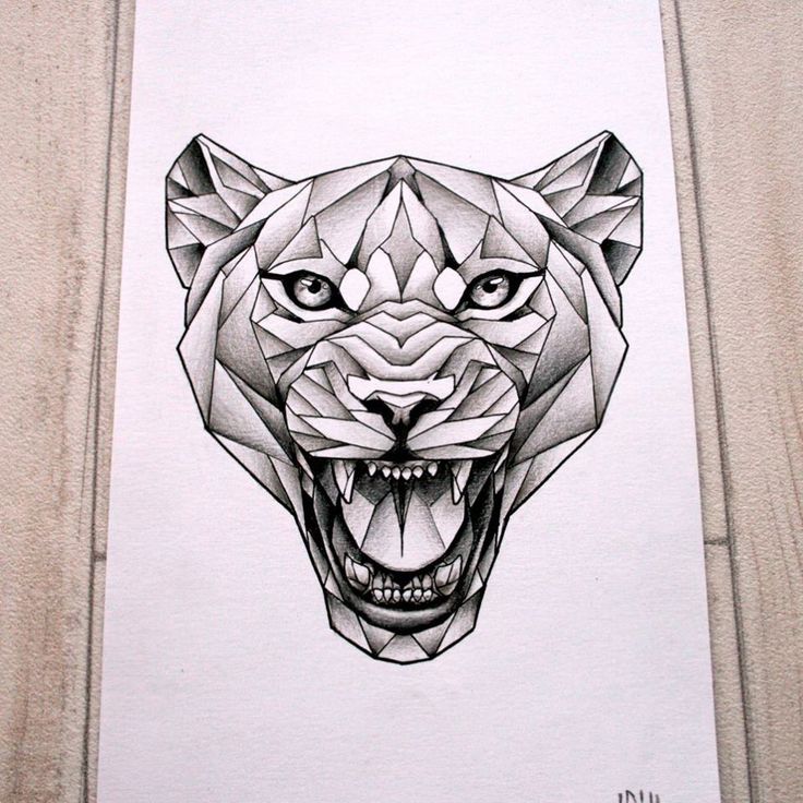 a black and white drawing of a tiger's head with sharp teeth on a piece of paper