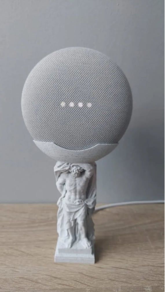 a white speaker sitting on top of a wooden table