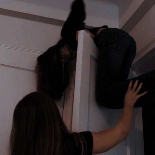 a woman is trying to put her shoes in the closet