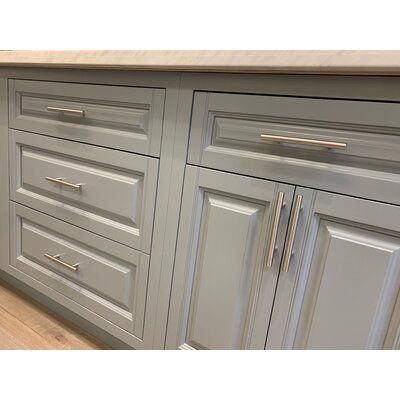 an image of a kitchen setting with cabinets and counter tops that are painted in light gray