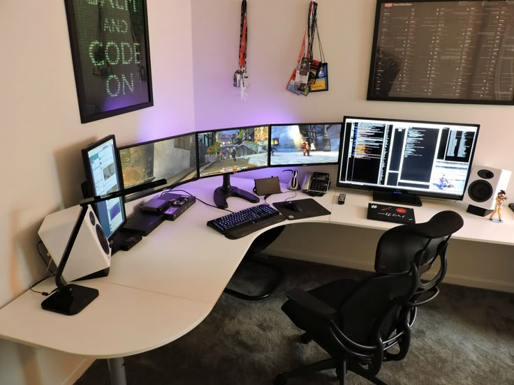 a computer desk with multiple monitors and keyboards