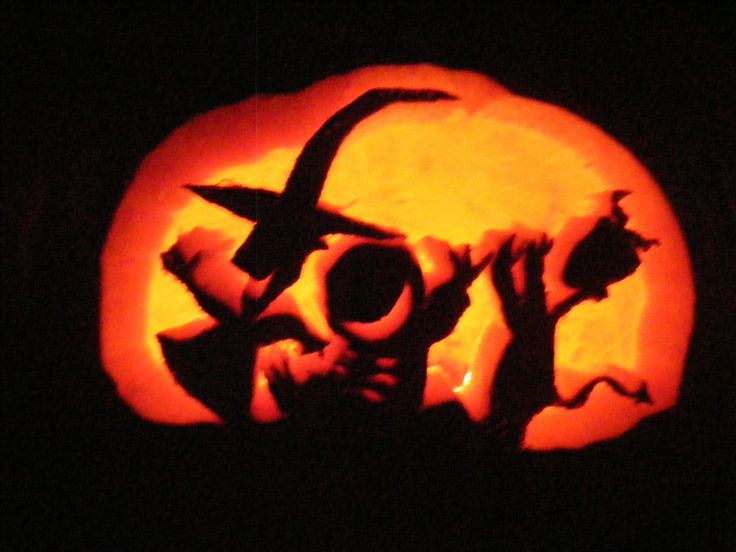 a carved pumpkin with the word joy on it's face and hands in silhouette