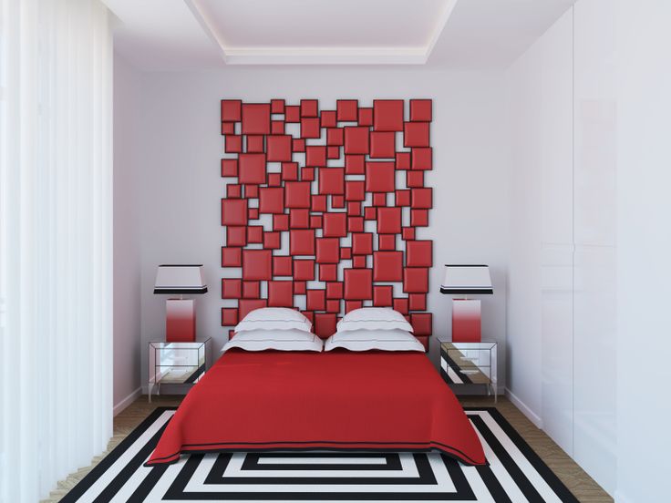 a bedroom with a red headboard and black and white rugs on the floor