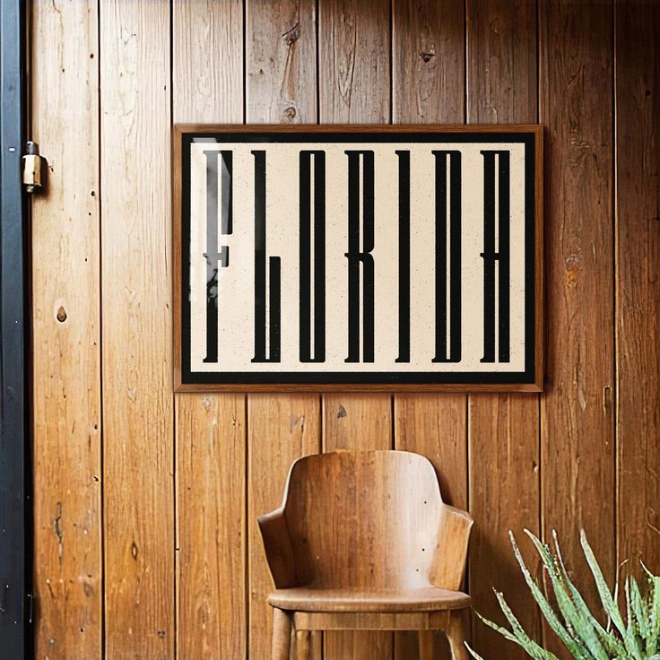 a chair sitting in front of a wooden wall next to a potted green plant