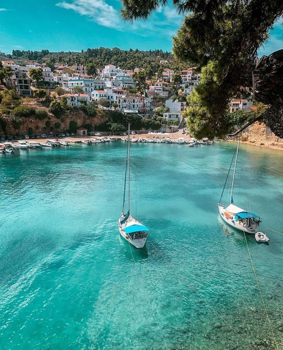 two boats floating in the clear blue water