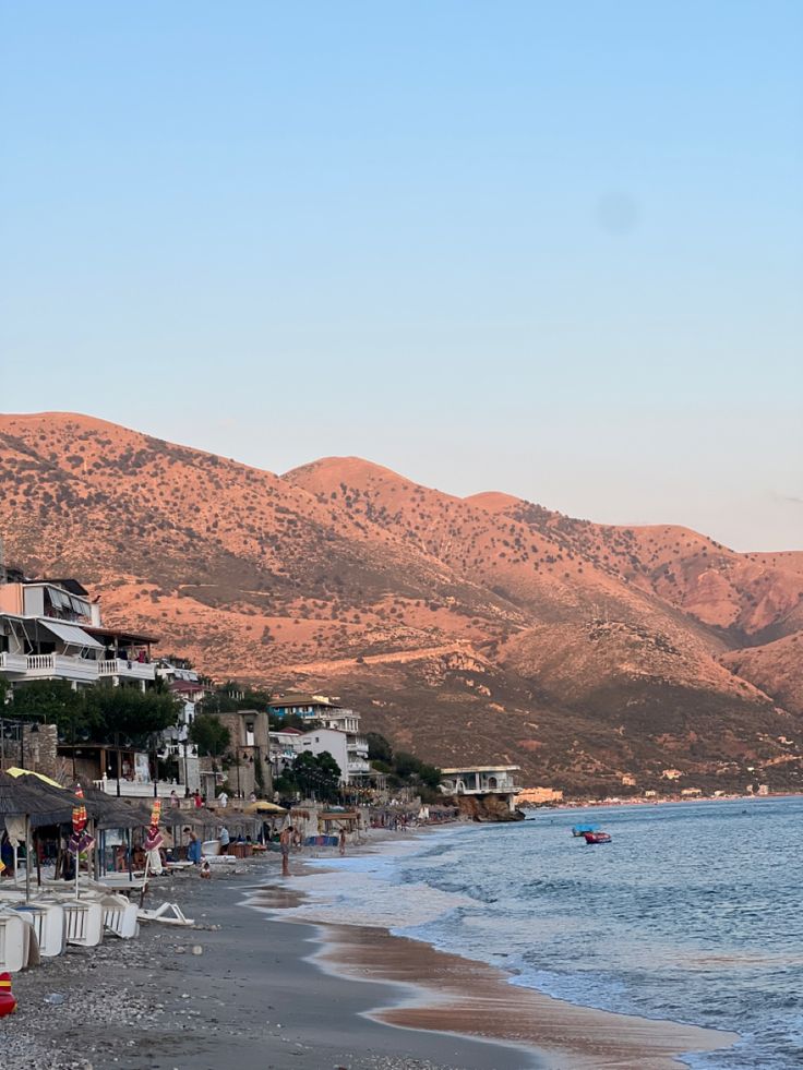 a beach with mountains in the background