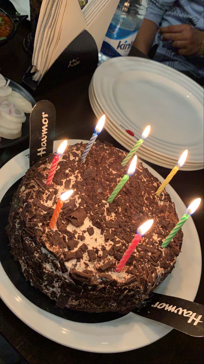 a chocolate cake with lit candles on it