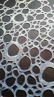 an image of water bubbles on the floor in front of a black tablecloth with white circles