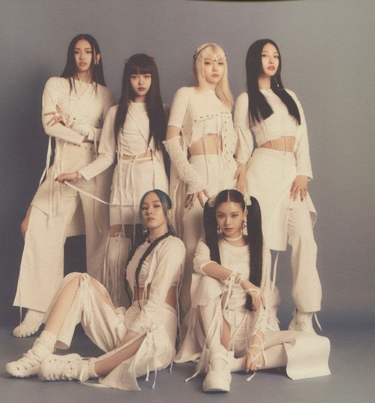 the girls are posing together in white outfits