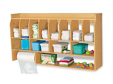 a wooden shelf filled with lots of different types of baby diapers and containers on it