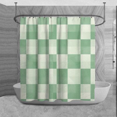 a green and white checkered shower curtain hanging in a bathroom next to a bathtub