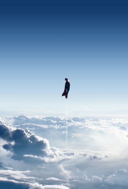 a man flying through the air on top of clouds