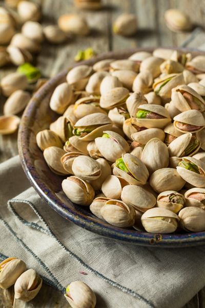 pistachio nuts in a bowl on a table