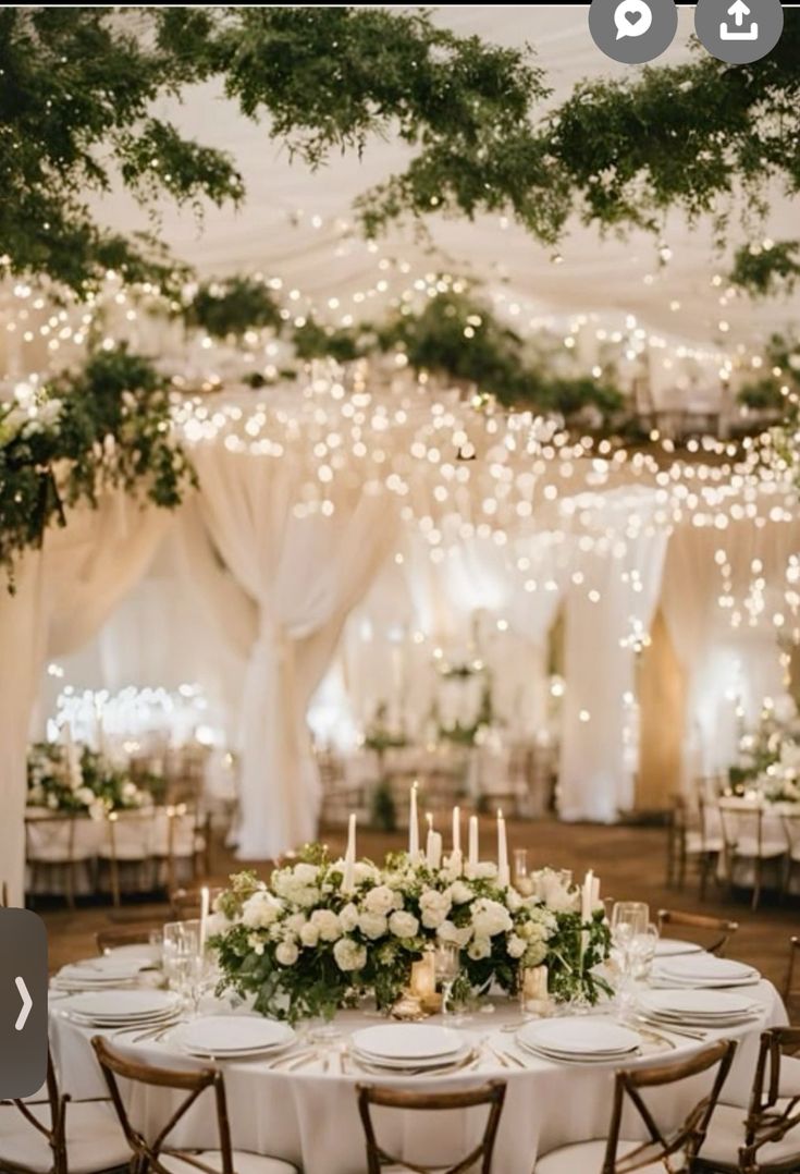 an image of a table set up with flowers and candles for a wedding or reception