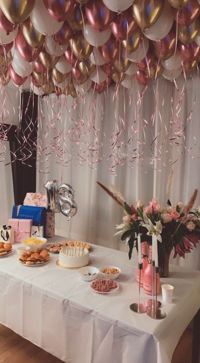 a table topped with lots of desserts and confetti on top of it