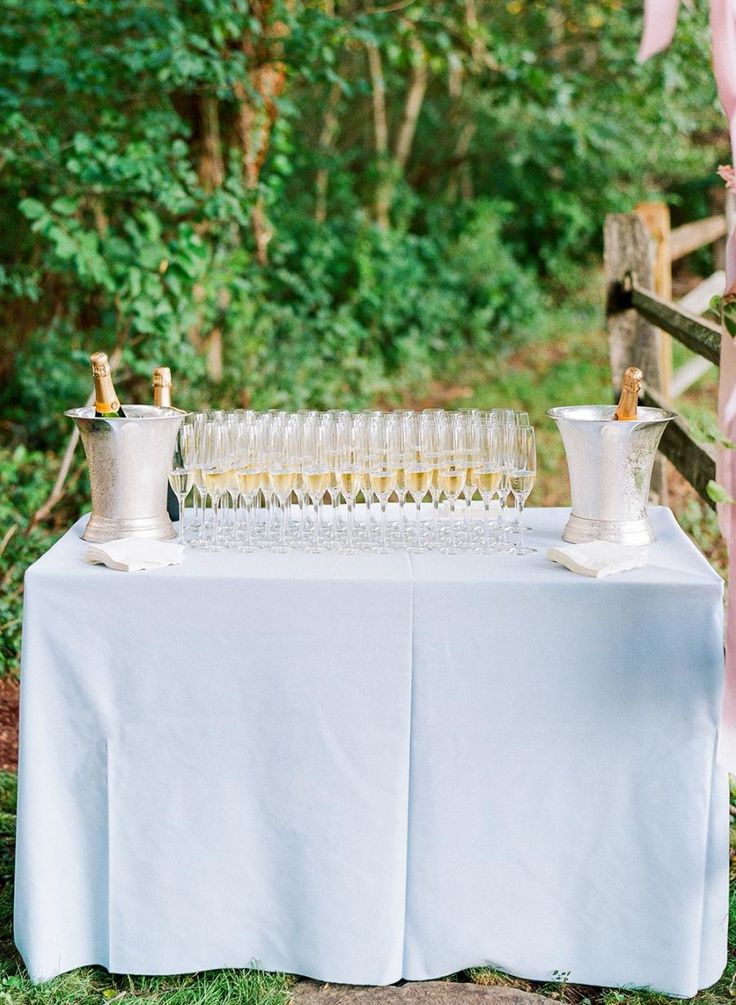 a table with champagne glasses and pitchers on it