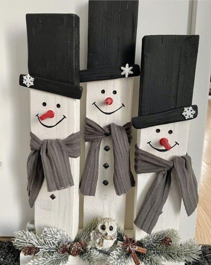 two snowmen are standing next to each other