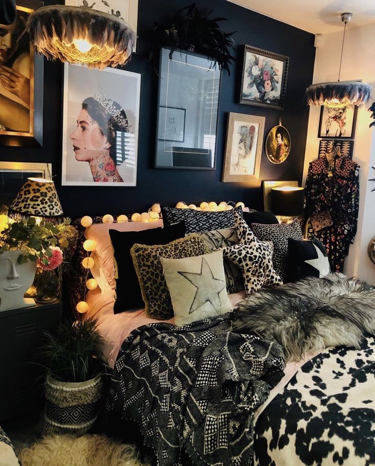 a black and white bedroom with pictures on the wall, leopard print bedding and pillows