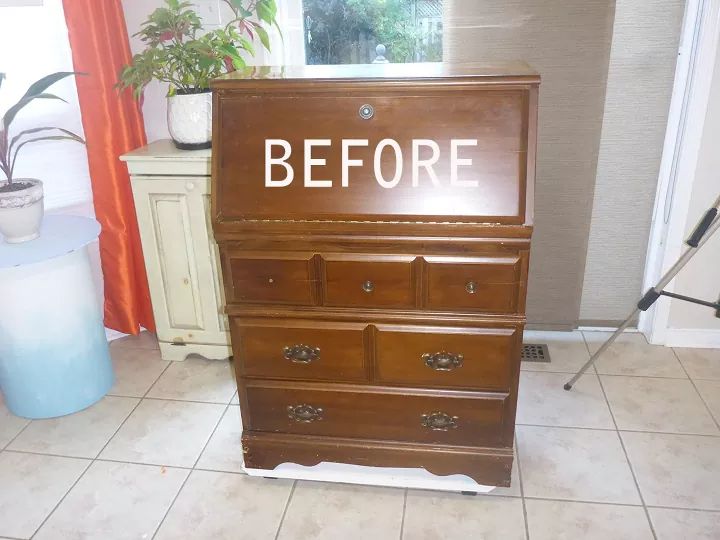 a wooden dresser with the words before painted on it in front of a window and a potted plant