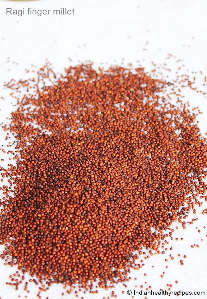 a pile of red seed sitting on top of a white table