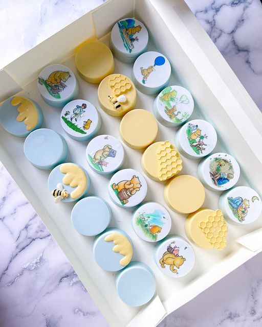 a box filled with lots of different colored buttons on top of a marble countertop