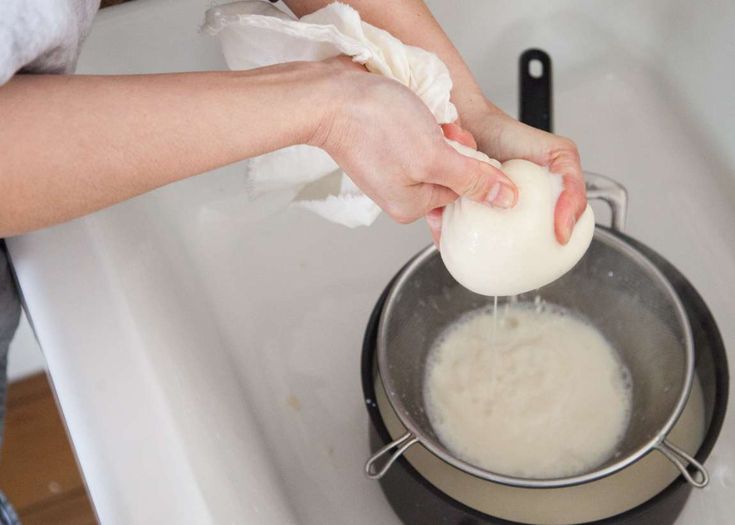 someone is washing an egg in a pot on the stove