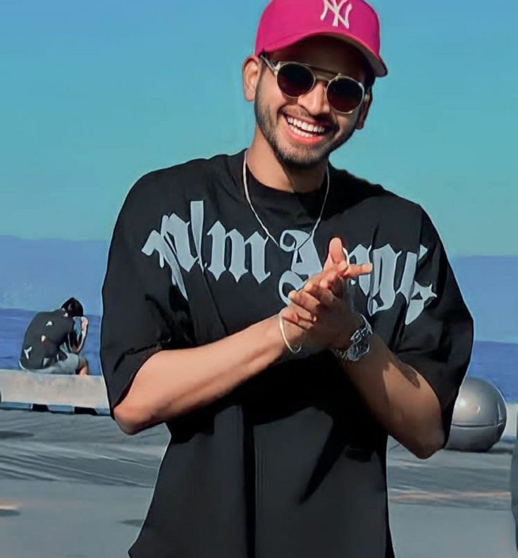 a man wearing a pink hat and sunglasses