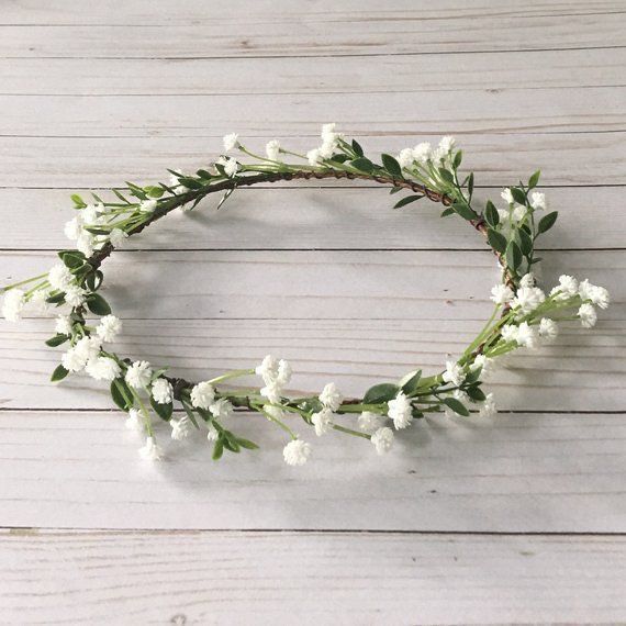 a white flower crown on top of a wooden table