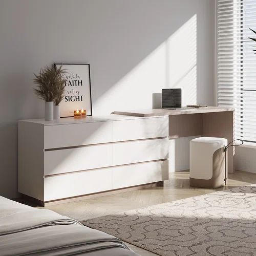 a bedroom scene with focus on the dresser and bed side table in the foreground