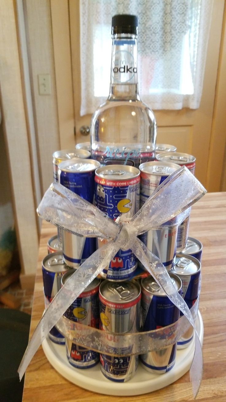 a stack of soda cans wrapped in white ribbon