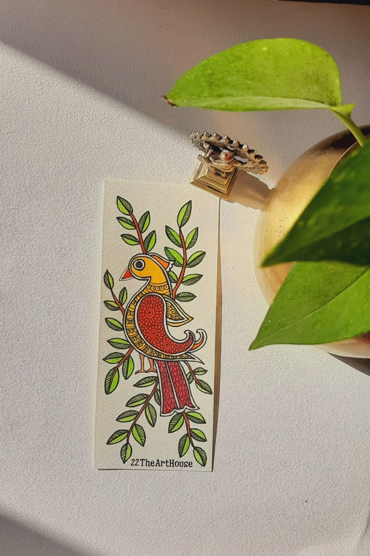 a sticker with a bird on it next to a potted plant