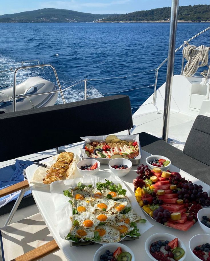 a table full of food sitting on top of a boat